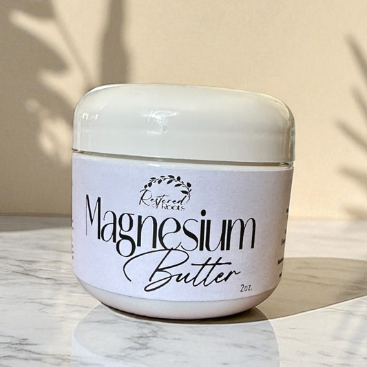 Jar of magnesium butter on a marble surface with a neutral background